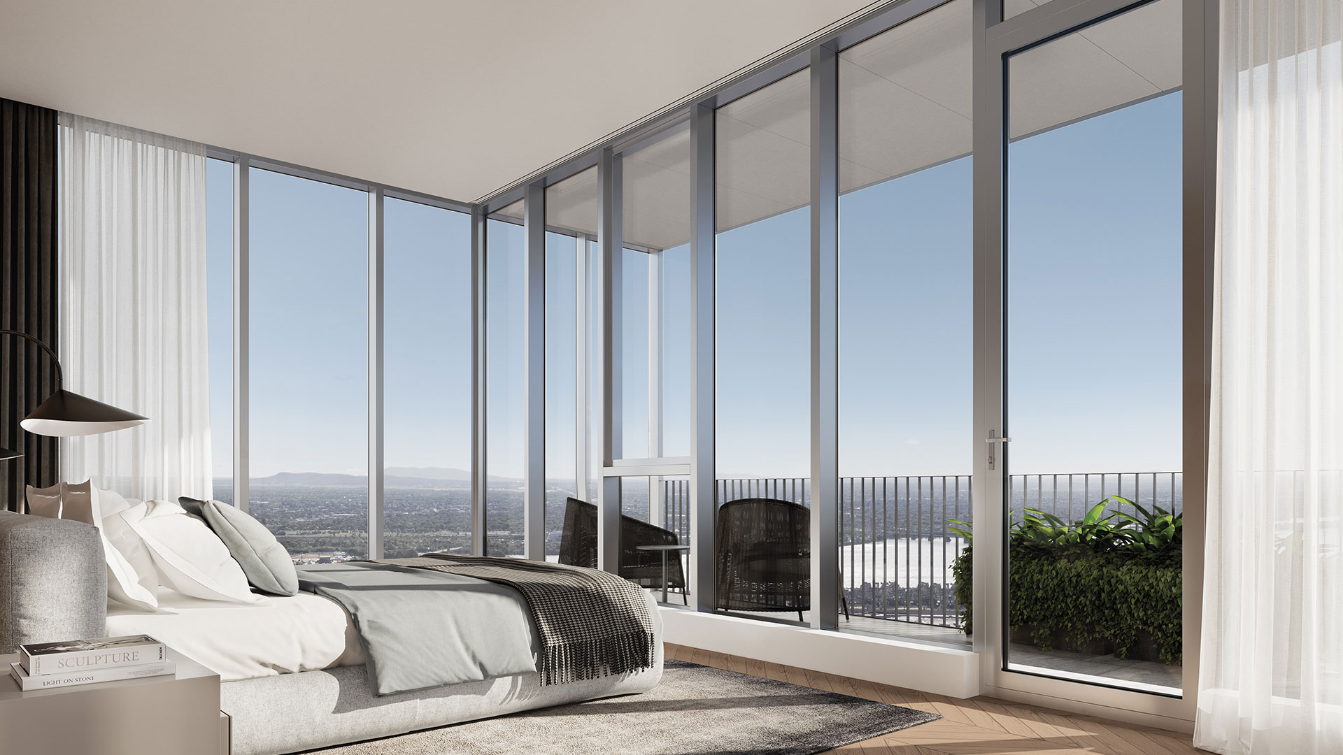 Chambre de maitre offrant une vue urbaine depuis un appartement du projet Square Phillips.